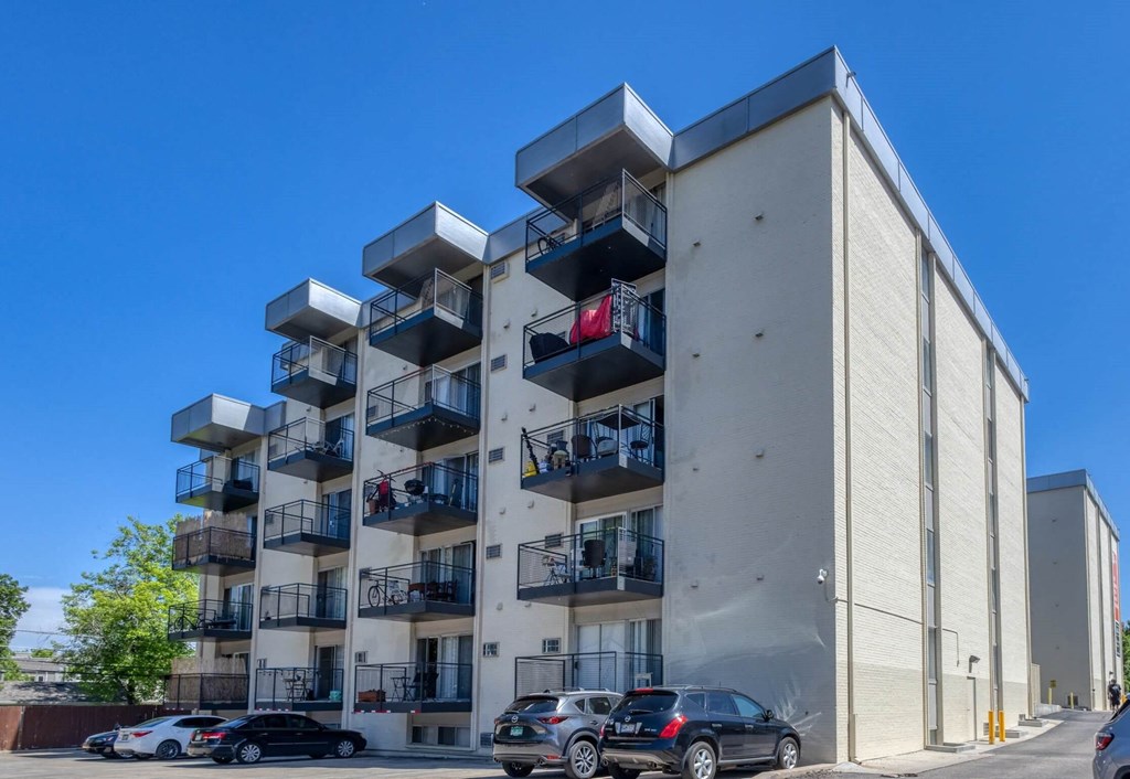 A modern apartment building with cars parked in front  at 4805 E Kentucky in Denver, CO