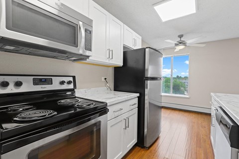 a kitchen with stainless steel appliances and white cabinets