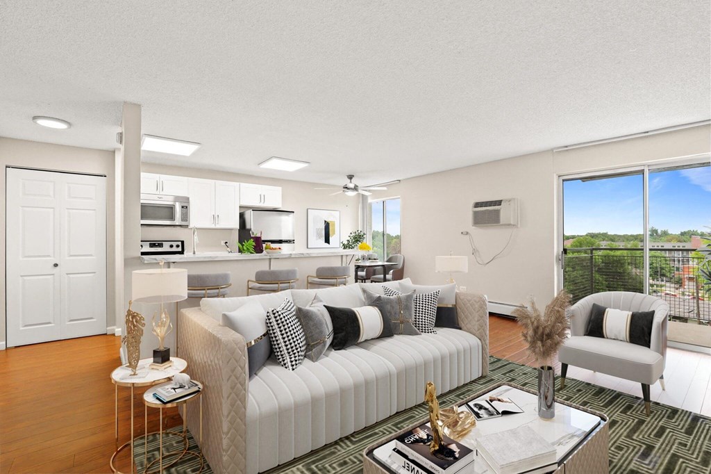 A modern living room with a large couch and a view of the outdoors  at 4805 E Kentucky in Denver, CO