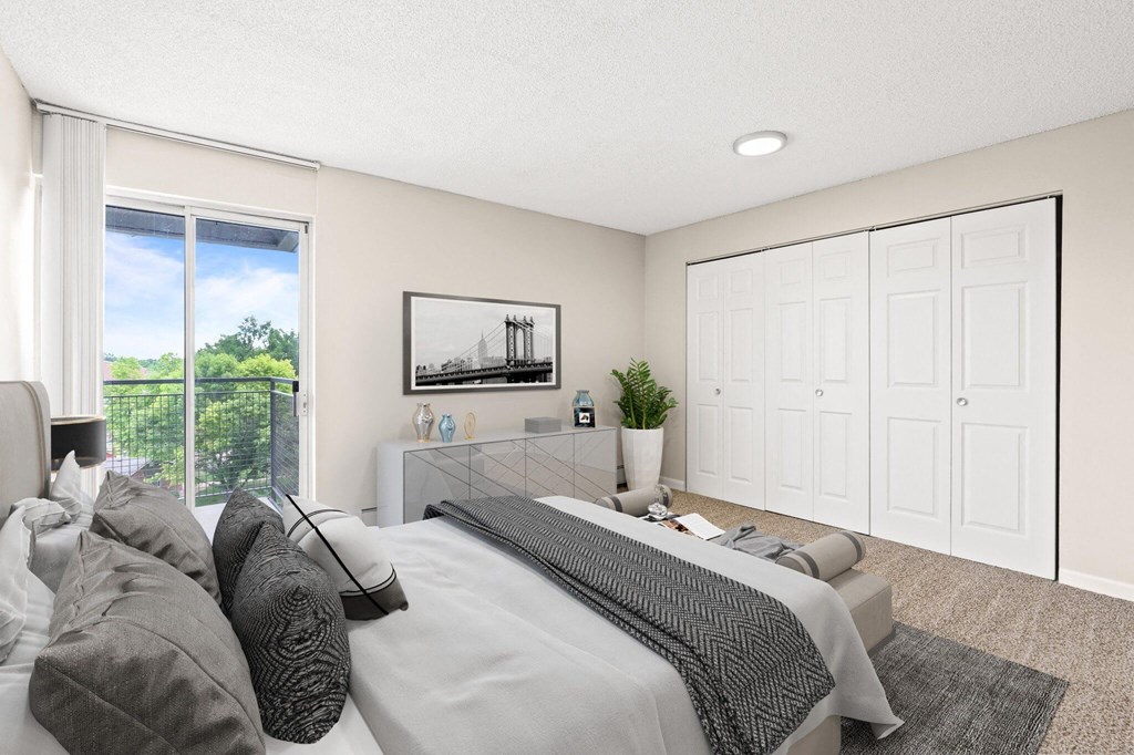 A bedroom with a large bed and a painting of a bridge on the wall  at 4805 E Kentucky in Denver, CO