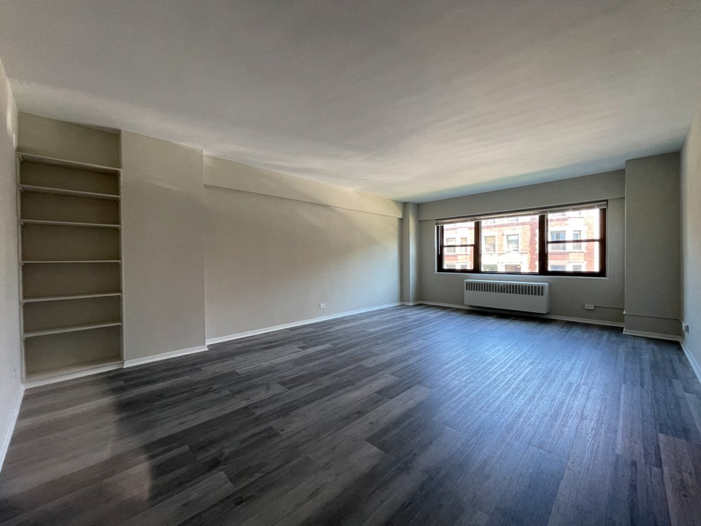 Open and airy living area with large windows and built-in shelving - Large 2 Bedroom  at 5550 S Dorchester, Chicago, Illinois