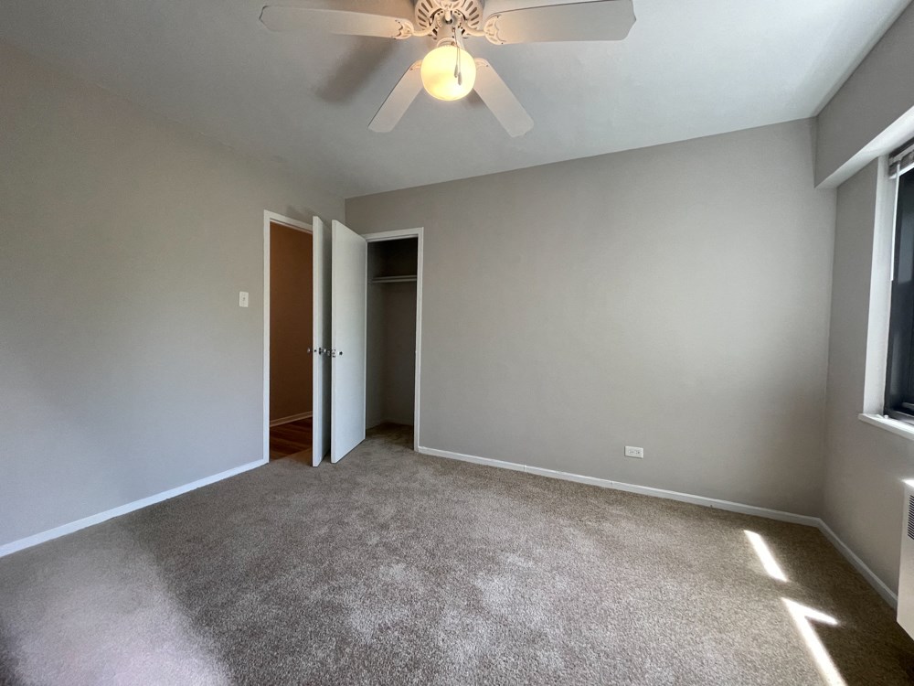 Second bedroom with a spacious closet and a ceiling fan - 2 Bedroom  at 5550 S Dorchester, Chicago, IL