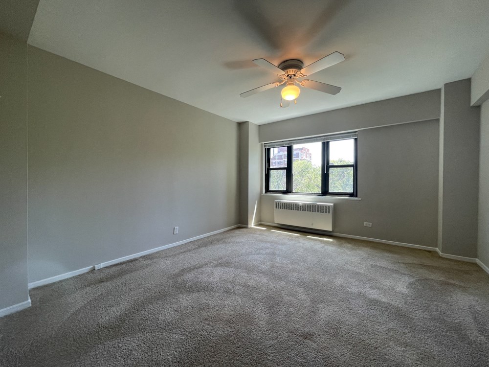 First bedroom with plush carpet and a ceiling fan - 2 Bedroom  at 5550 S Dorchester, Illinois