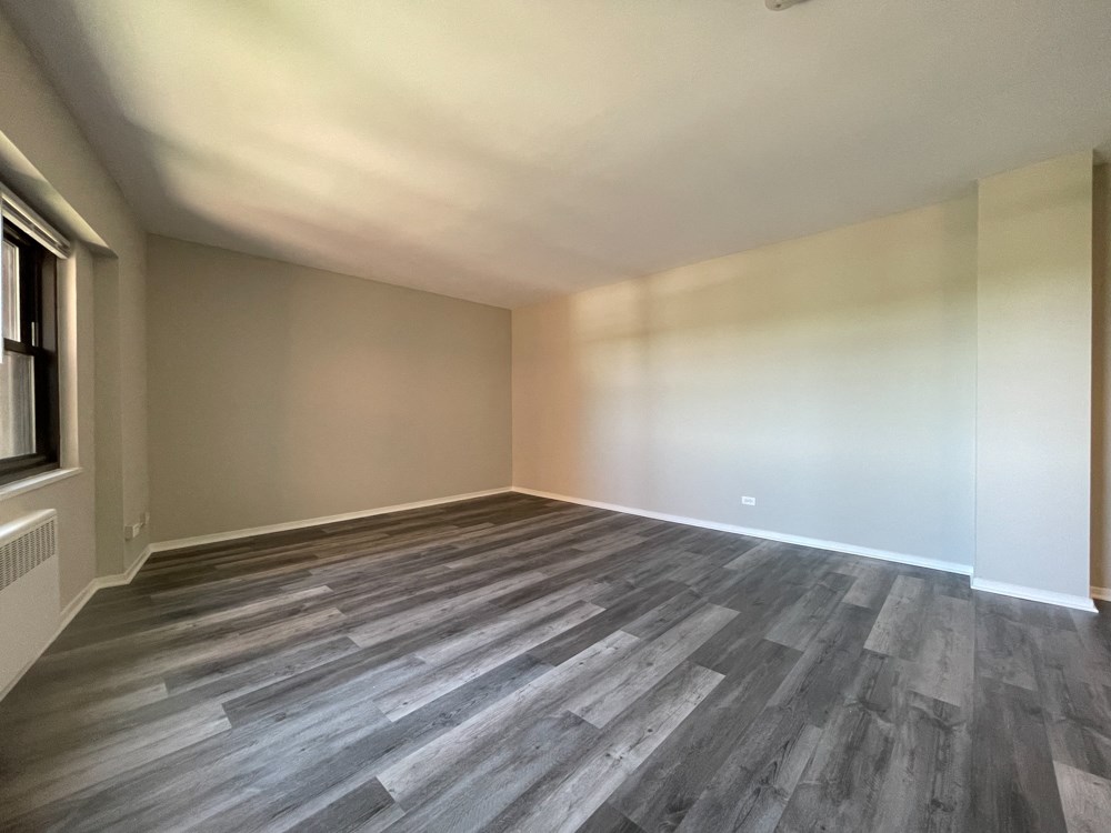 View of the living area from the kitchen - Studio  at 5550 S Dorchester, Chicago, IL