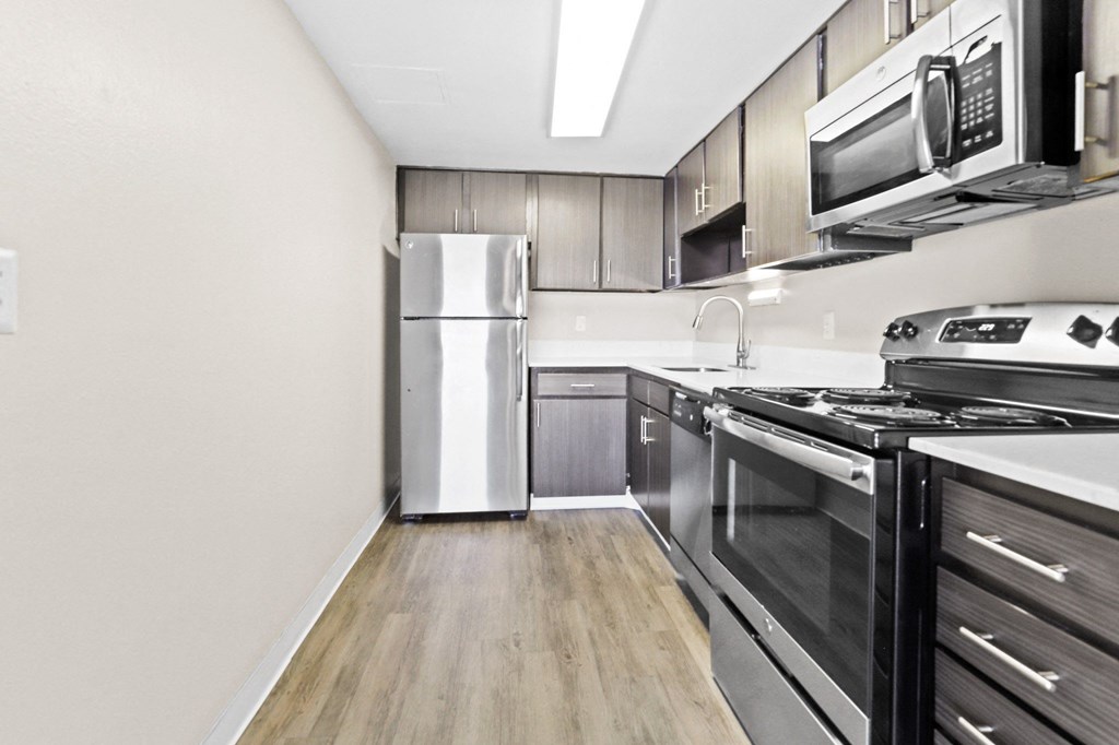 A kitchen with a stainless steel refrigerator and a stainless steel stove at 878 S Dexter St in Denver, CO