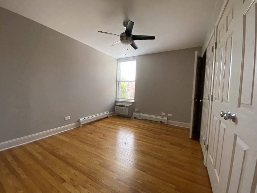 Bedroom with a ceiling fan and large closets - Two Bedroom