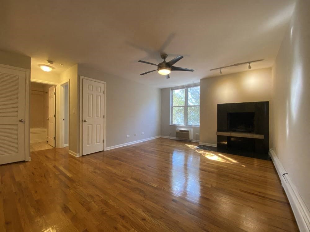 Spacious living area with hardwood flooring - Large One Bedroom