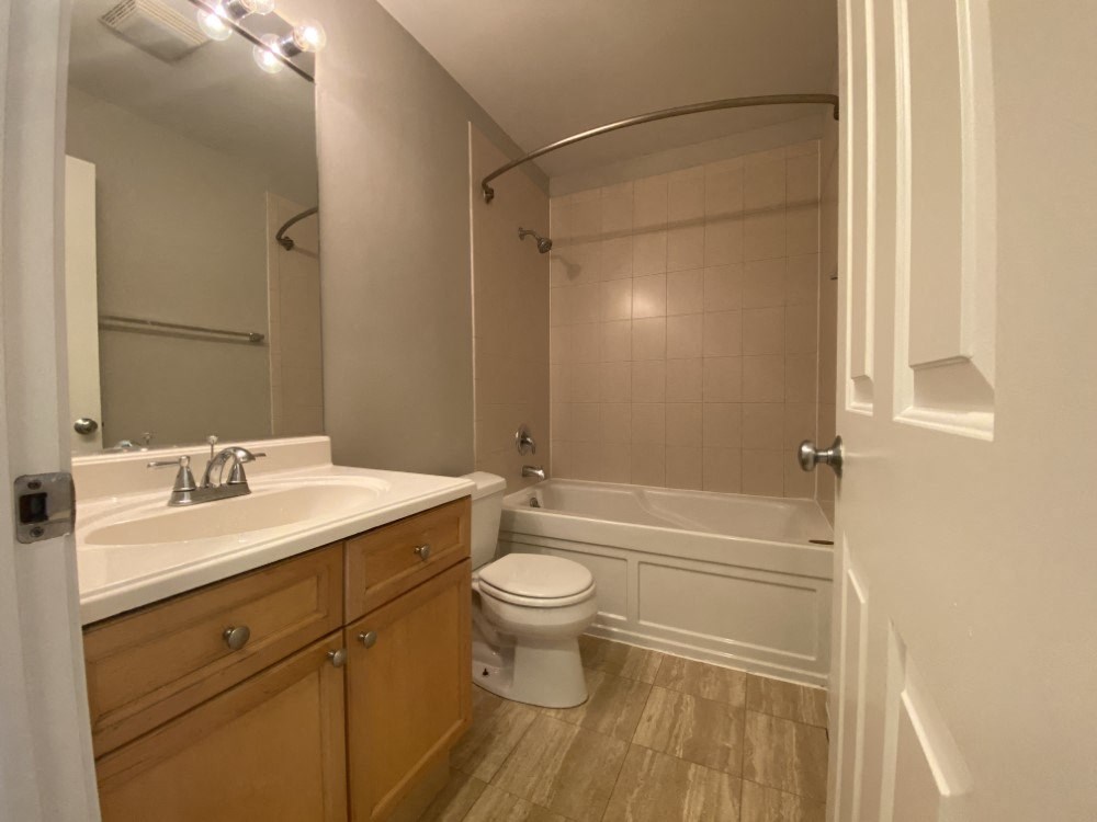 Bathroom with vanity storage and a full tub - Large One Bedroom