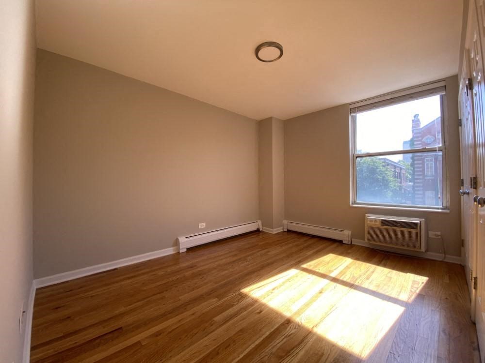 Sunny bedroom with hardwood floors - One Bedroom