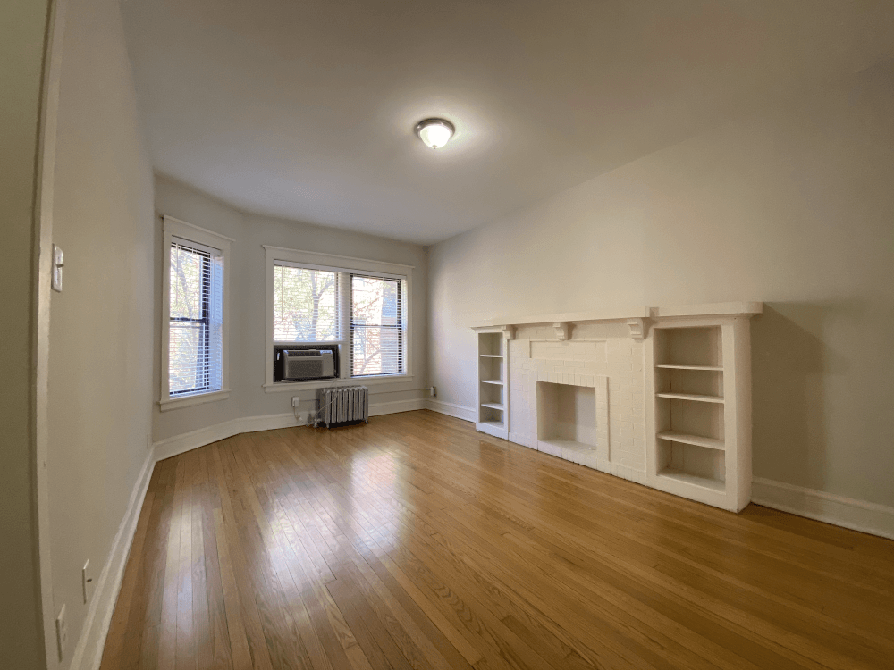 Spacious living area with decorative fireplace