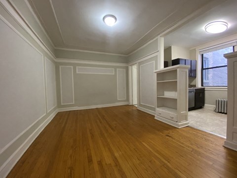 Spacious living area with hardwood flooring