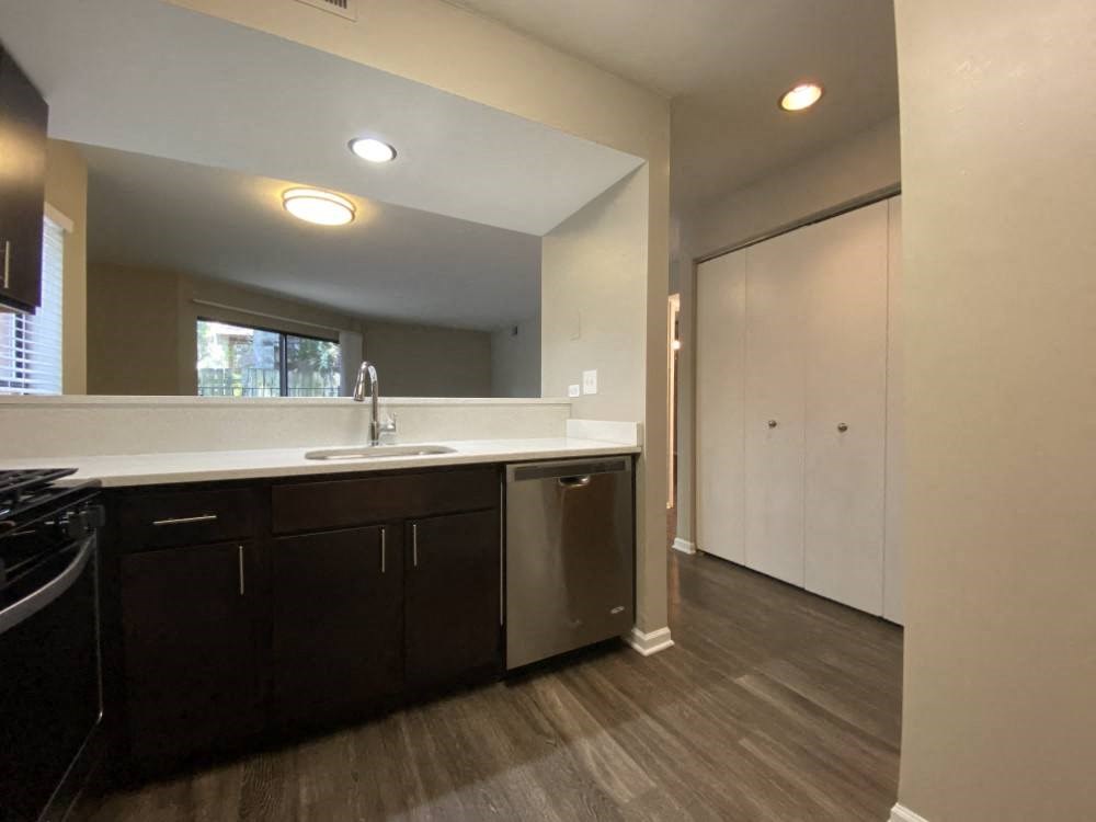 Spacious kitchen with rich flooring