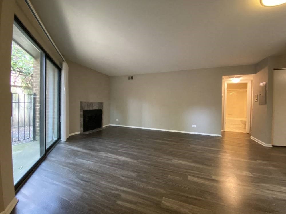 Neutral paint color and rich wood plank flooring