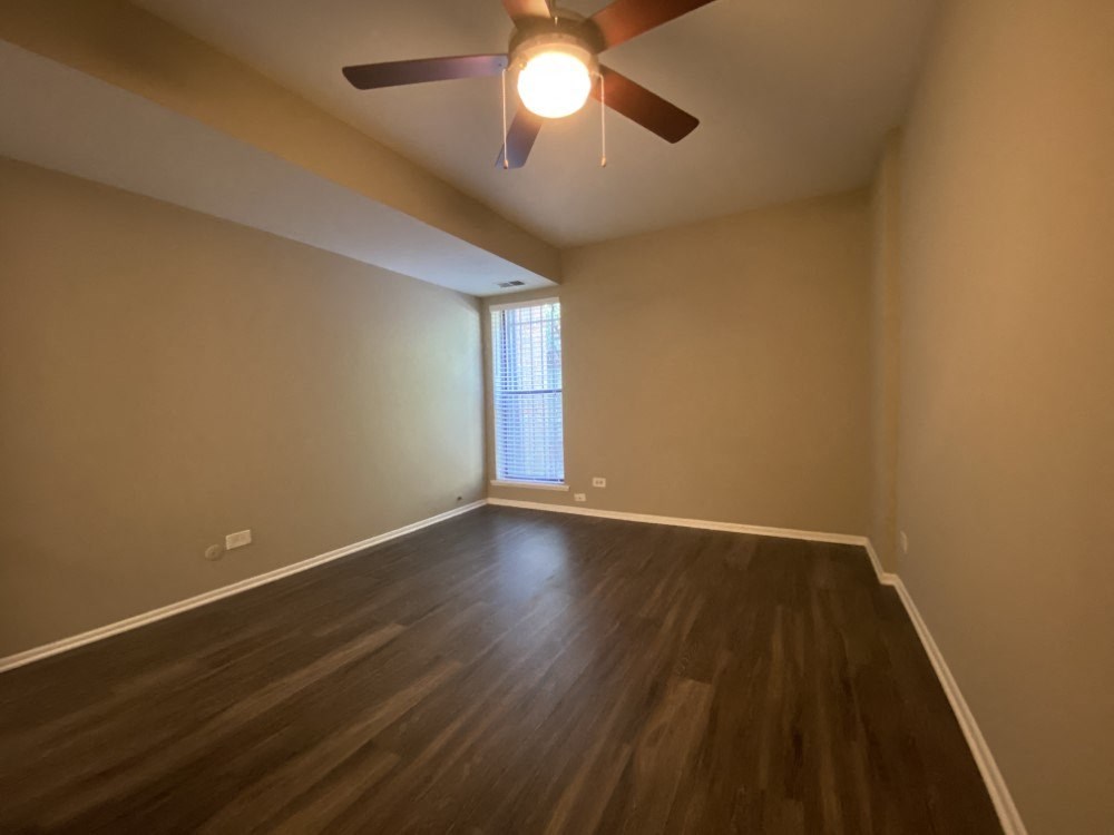 Large bedroom with a ceiling fan