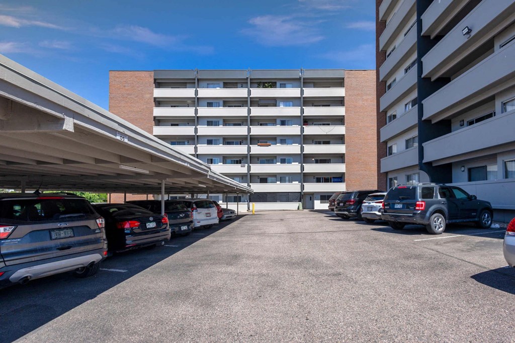 A parking lot with cars and a building in the background at 878 S Dexter St in Denver, CO