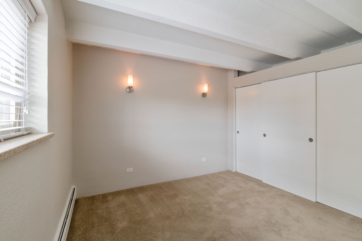 Bright and large bedroom with designer lighting