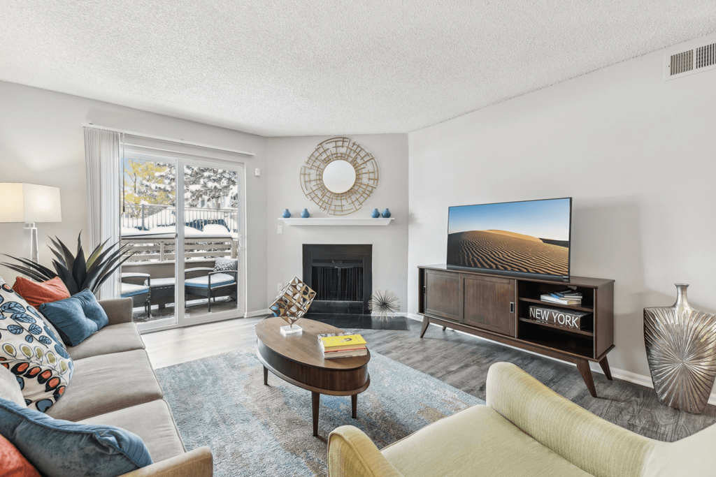 a living room with a couch and a tv and a fireplace