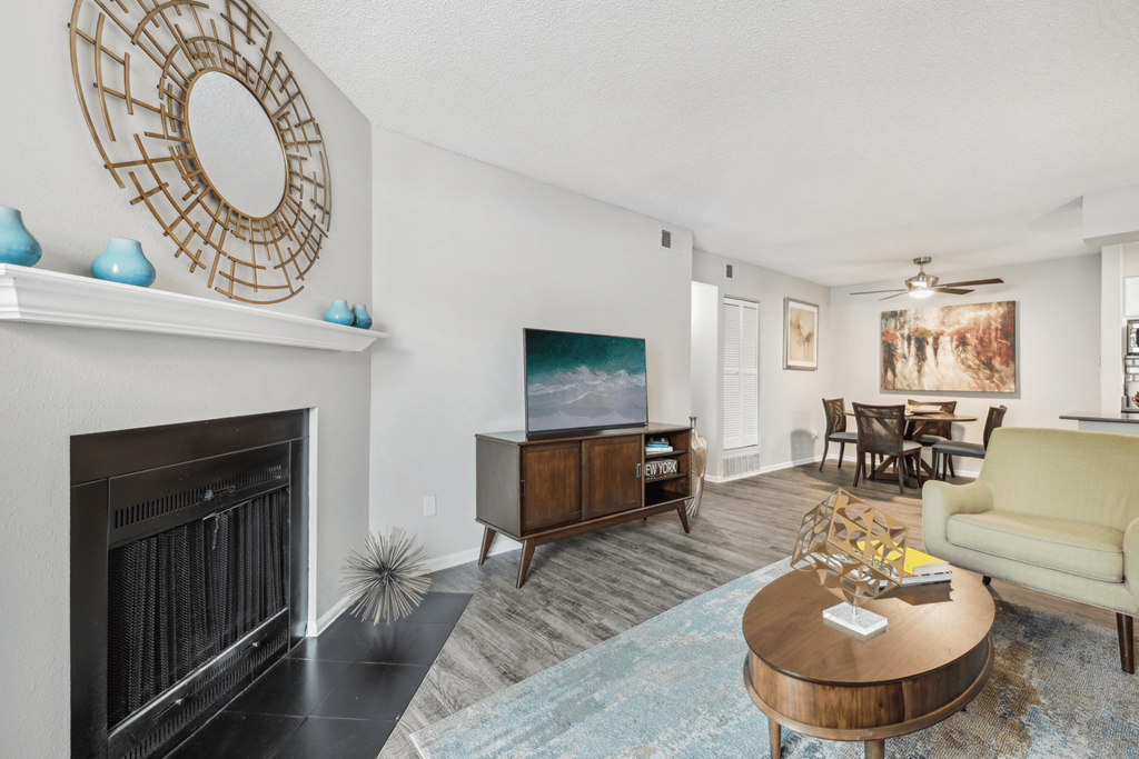 a living room with a fireplace and a tv