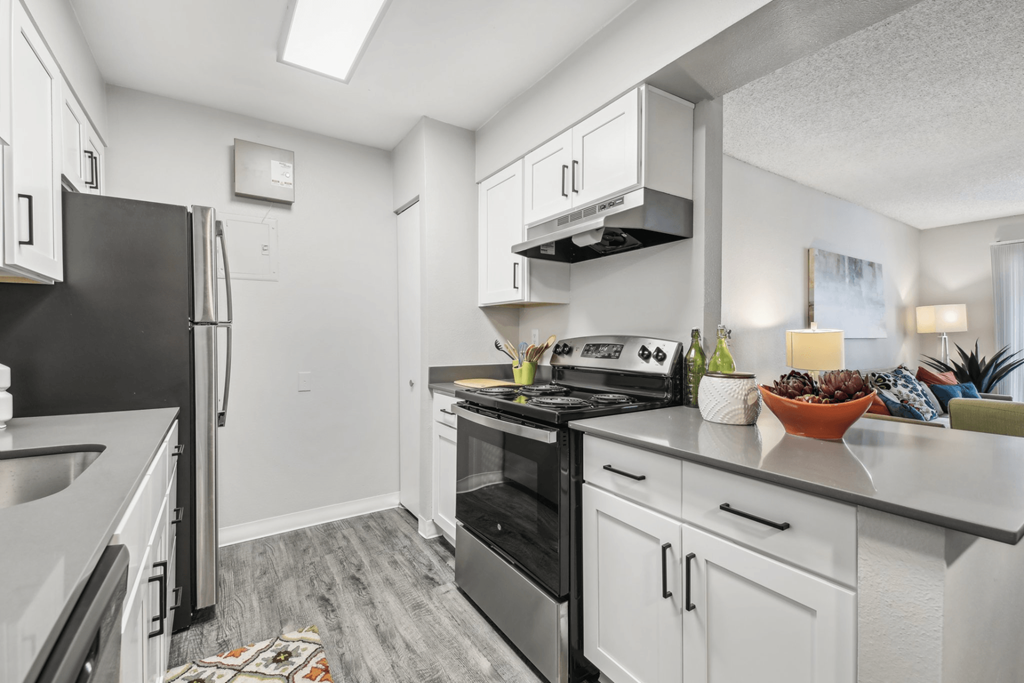 a kitchen with stainless steel appliances and white cabinets