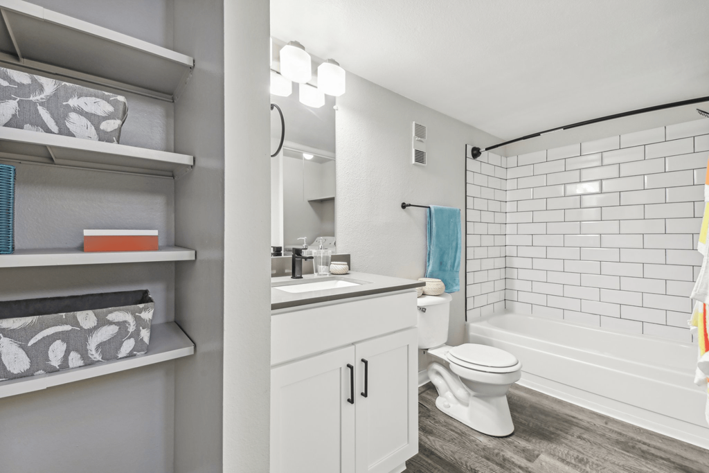 a white bathroom with a white toilet and a tub and a sink
