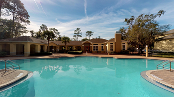 A large swimming pool surrounded by a building.