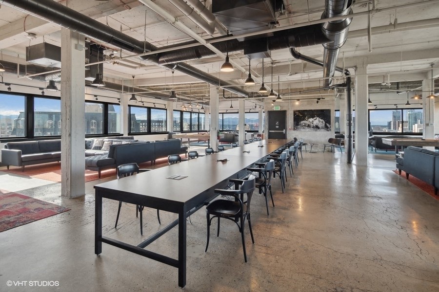 a long table and chairs in a large room in a building