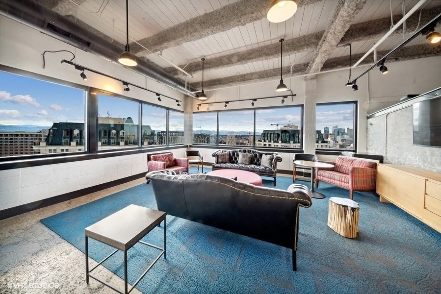 a living room with a couch and a view of the city