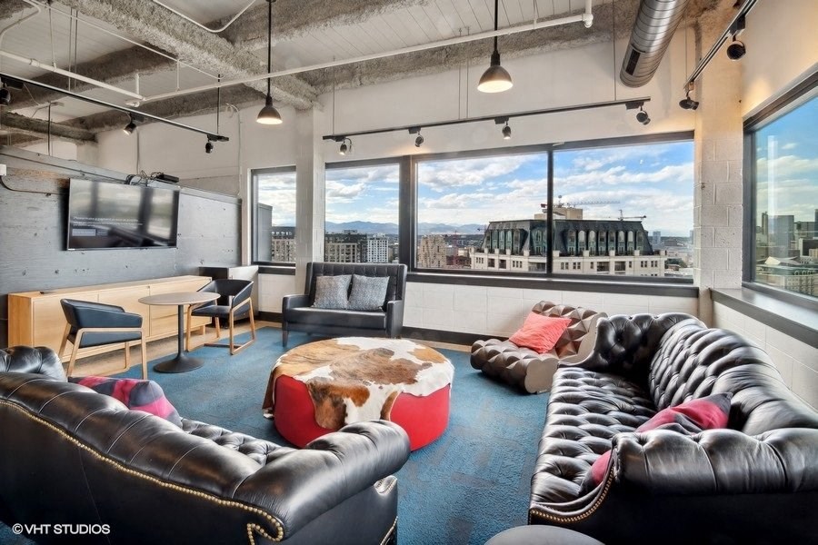 a living room with couches and a tv in a loft apartment