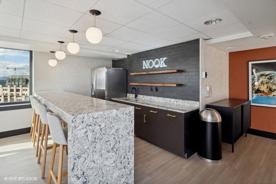 a kitchen with a marble counter top and a refrigerator