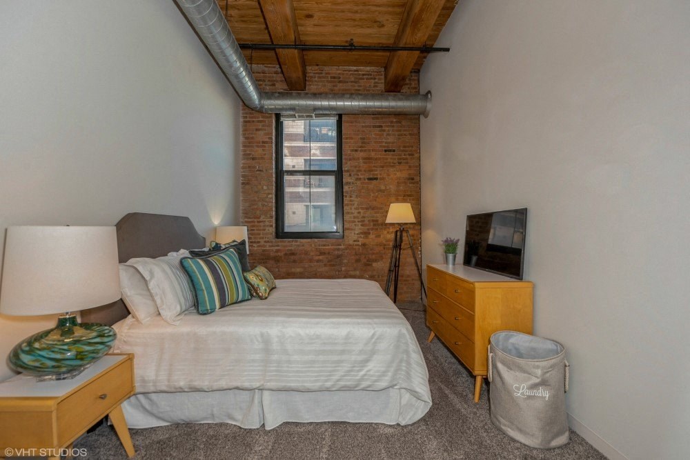 Bedroom with plush carpeting at Carriage House Lofts, Chicago, Illinois