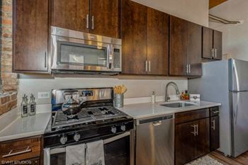 a kitchen with stainless steel appliances and wooden cabinets