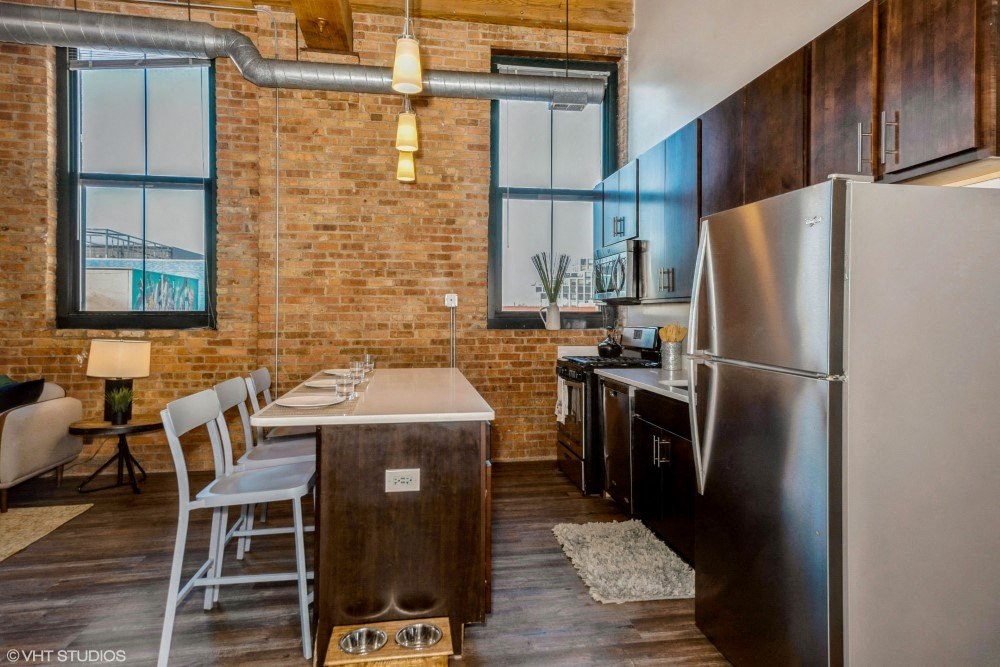 Kitchen with a breakfast bar at Carriage House Lofts, Chicago, IL