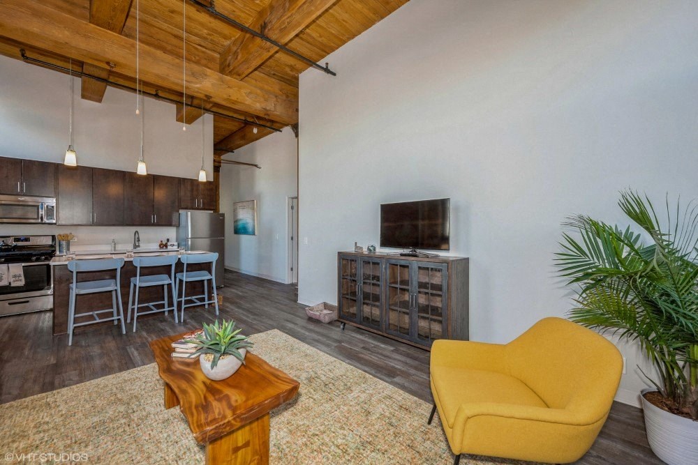 Open concept layout with gorgeous updated flooring and vaulted ceilings at Carriage House Lofts, Chicago, IL