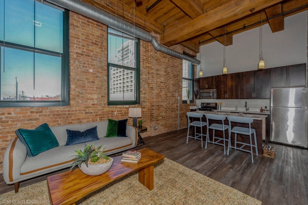 Exposed brick walls and ceiling beamsat Carriage House Lofts, Chicago, Illinois