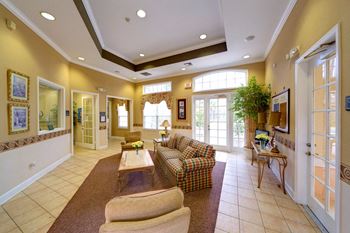 A living room with a couch, chairs, and a coffee table.