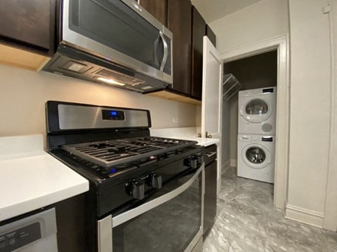 a kitchen with a stove and a microwave and a washing machine