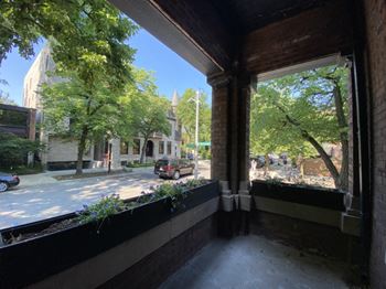 Enjoy your own private porch with charming street views and leafy green surroundings—perfect for a morning coffee or a peaceful evening unwind at your Laramar home.