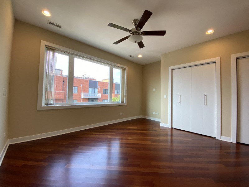 Large bedroom with hardwood floors