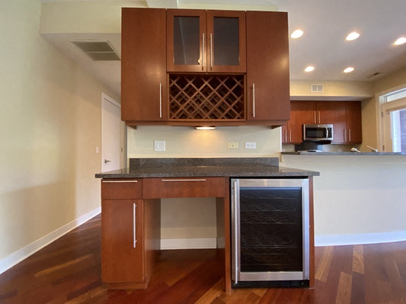 Gorgeous built-in desk with a wine cooler and wine rack