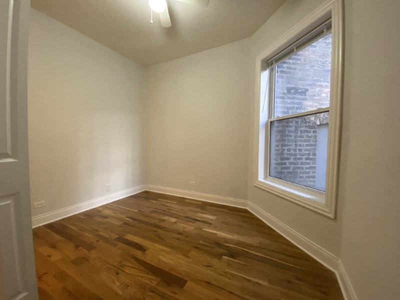 Bright bedroom with hardwood floors and natural light