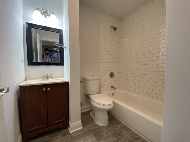 All-white bathroom with a tile backsplash