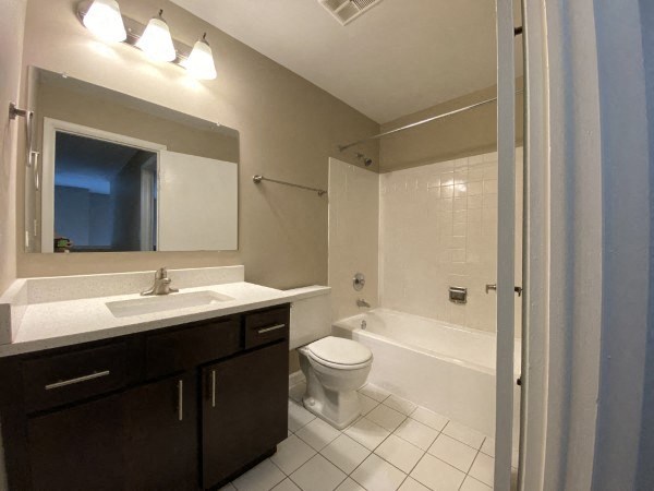 Bright bathroom with dark cabinetry