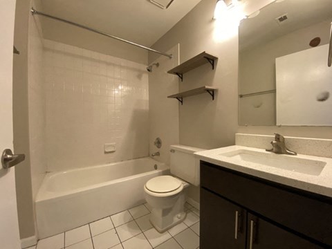 Bathroom with vanity storage and a full tub