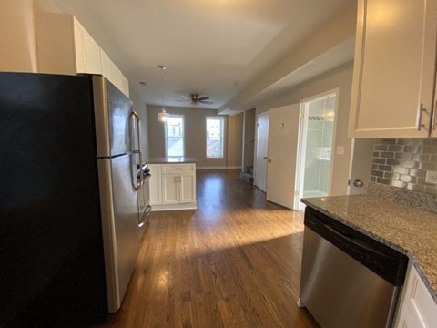 a kitchen with a stainless steel refrigerator