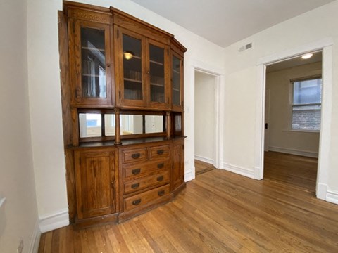 a living room with a hutch and a door to a hallway