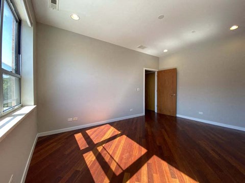 Large bedroom with hardwood floors