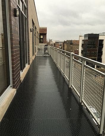 a balcony with a metal railing and a building