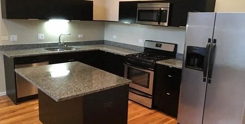 a kitchen with granite counter tops and stainless steel appliances