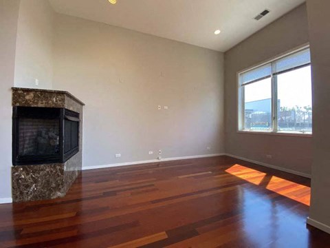 a living room with a fireplace and wooden floors