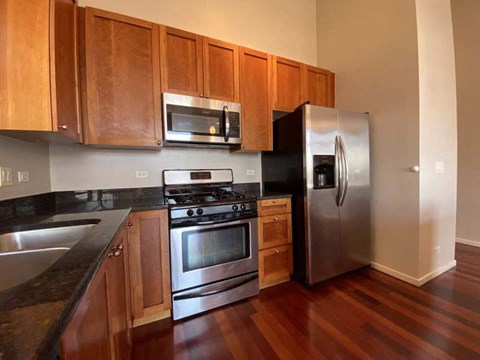 a kitchen with stainless steel appliances and wooden cabinets